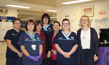 Seven women from the Rockingham General Hospital chemotherapy unit stand in a treatment area
