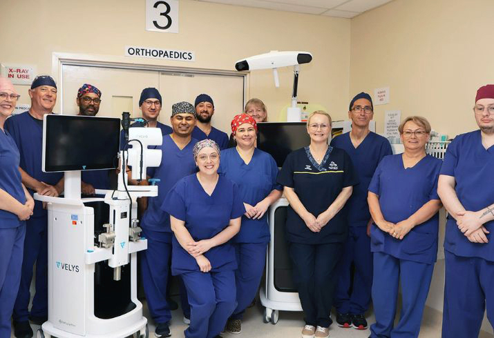 Members of the Rockingham General Hospital Orthopaedic service stand beside the new VELYS Robotic Assisted Solution 