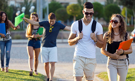 A group of young adults walking in a park